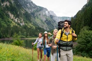 Group of hikers exploring a green mountain landscape, symbolizing natural endurance, wellness, and gut health benefits of CBD